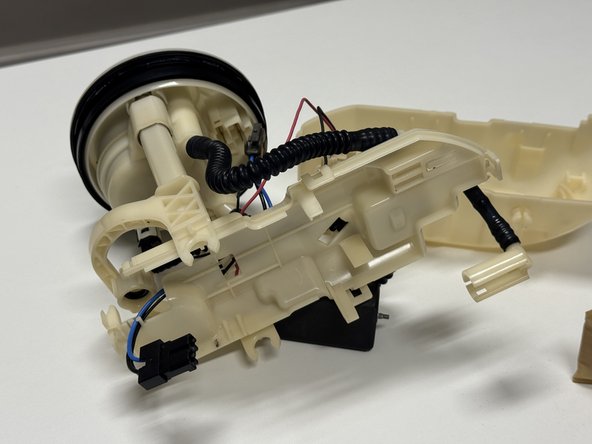 Unplug and remove the fuel pump from the cage.