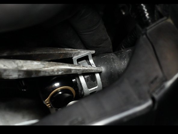 Re-install the heater hose onto the new outlet fitting.