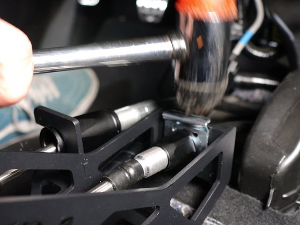Reinstall the shifter cable clips and secure them in place with a mallet if necessary.