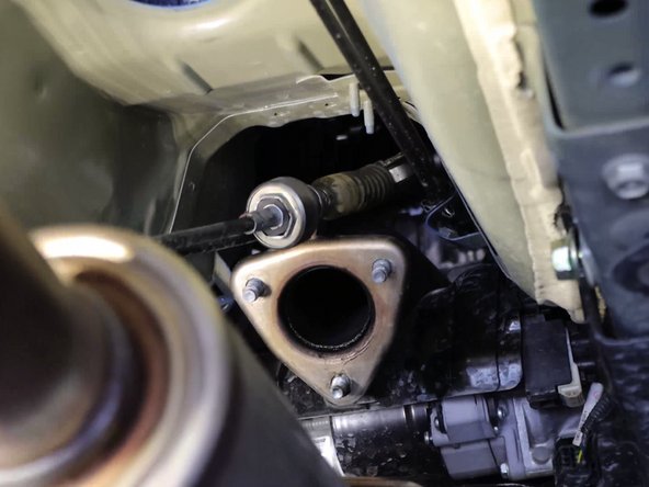 Slide the shifter cables out of the car. Be sure nothing gets caught up in the engine bay.