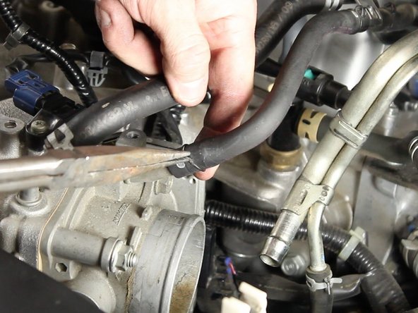 Unclamp and remove the vacuum hose for the purge control valve solenoid from the throttle body.
