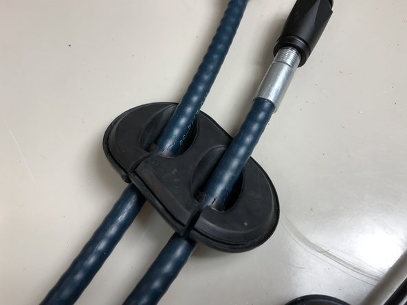 Slide the OEM cable seal on the Hybrid Racing cables. Make sure you cut enough so the seal will squeeze around the cables.