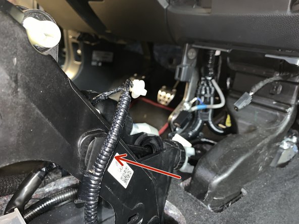 Remove the clips that hold the wiring harness to the factory shifter.