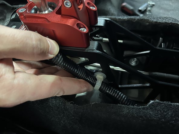 Reinstall the factory wiring harness so it clips into the shifter base.