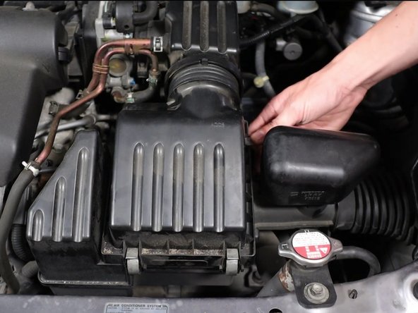 Unclip the four clips holding the airbox lid in place.