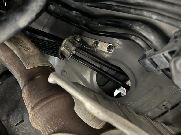 Tighten 10mm bolt, the push bracket onto studs.