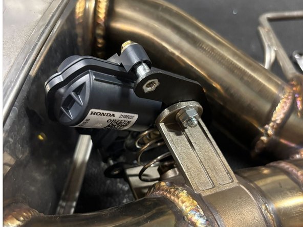 Attach the adapter bracket to the HR muffler assembly using the supplied hardware. Pay attention to the orientation.