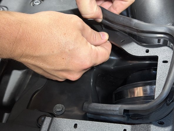 The trim seals the lid against the hood.