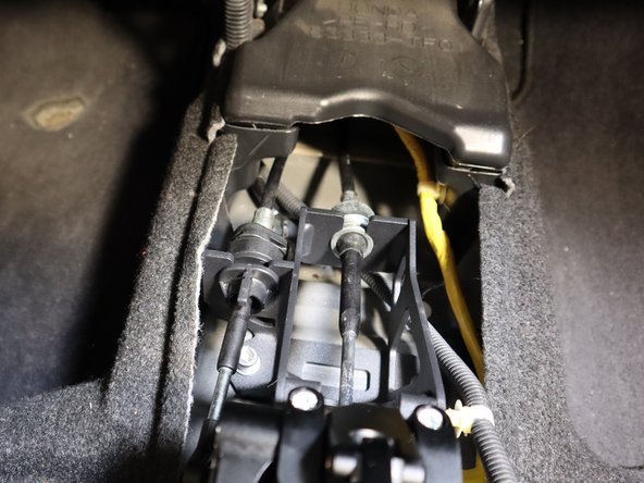 Re-install the shifter cables and shifter cable clip.