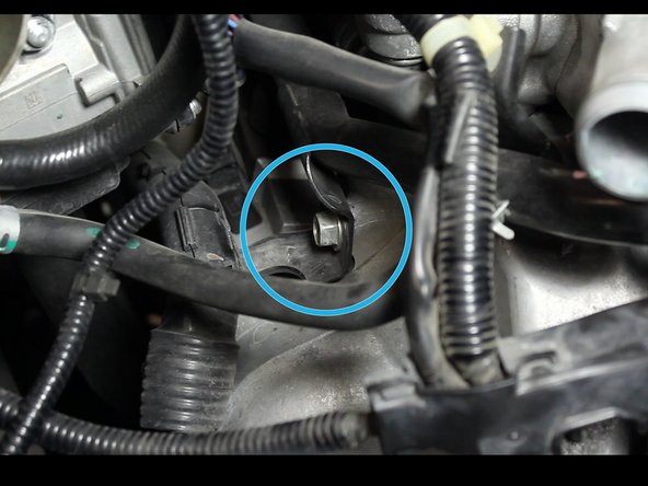 Remove the nut that holes the heater hose pipe in place.