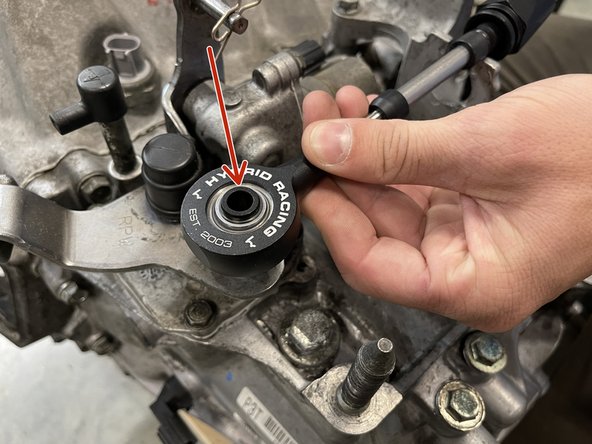 Insert the shifter cable end link onto the gear selector.