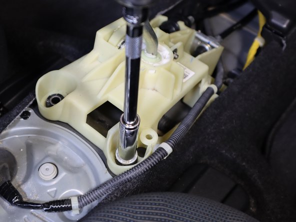 Use a trim tool to remove the clip holding the wiring harness in place. Once the wiring harness is out of the way, remove the Rear Right hand side bolt.