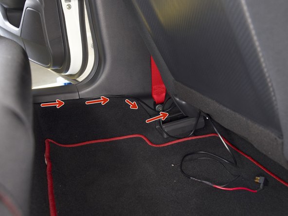 Route the harness under the panels along the sill. You can tuck the wiring under the panels, under the seat belt mount.