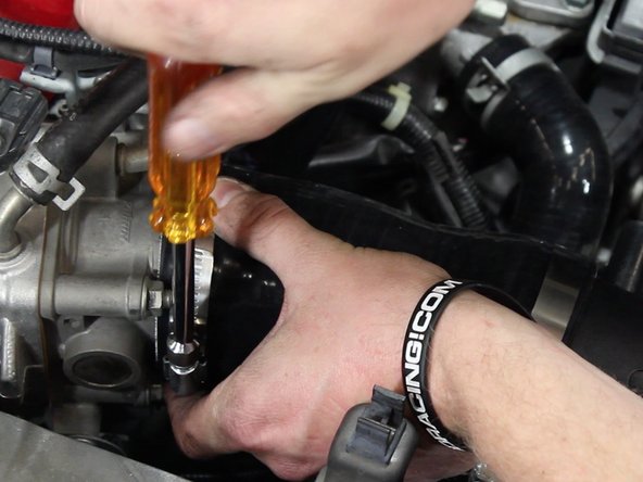 Slide the intake onto the throttle body and tighten the hose clamps.