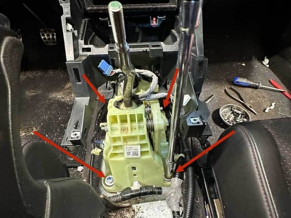 Remove the four 12 mm shifter mounting bolts.