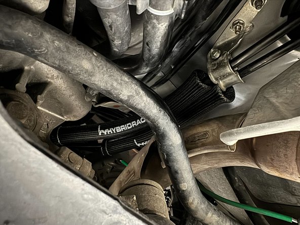 Pull heat sleeve down cables until it touches exhaust tunnel bracket.