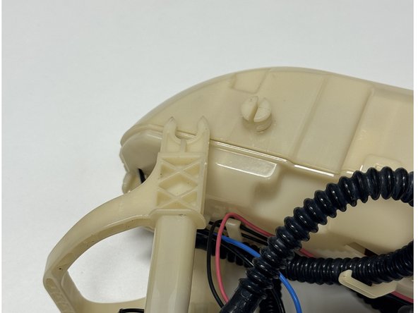 Unclip the lower fuel pump cage from the main housing.