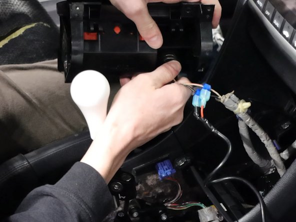 Remove the coin pocket and unplug the 12v socket.