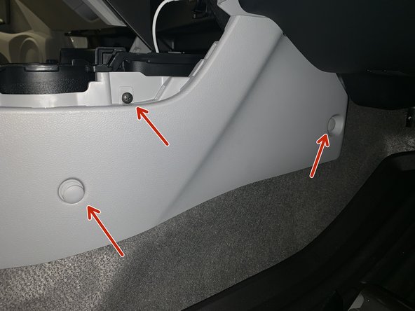 Remove the console clips and screws. There are two clips and one screw on each side.