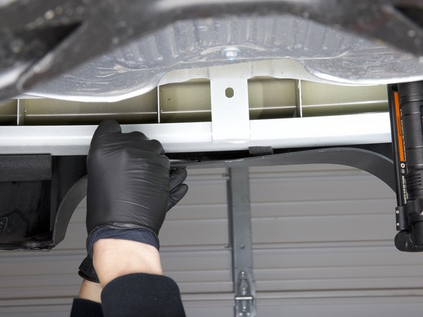 Remove the two outer retaining clips using a trim tool.