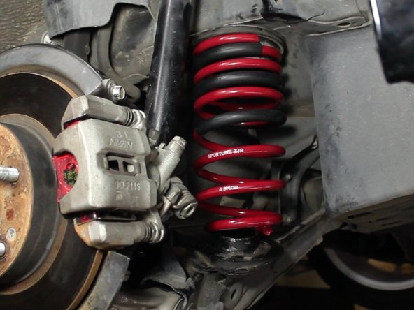 The lower spring perch should remain on the lower control arm.