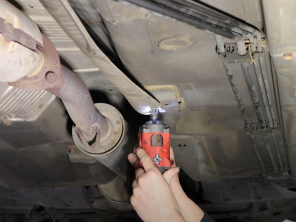 Remove the four 10mm bolts holding the heatshield in place. Slide the heatshield out of the way.