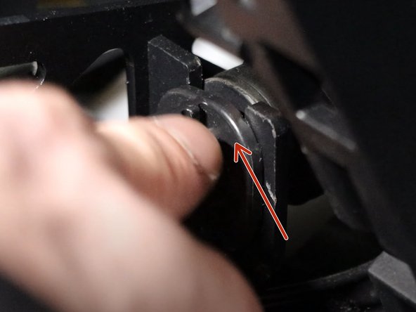Rotate the left side shifter cable counter-clockwise and slide it upwards, removing it from the shifter base.