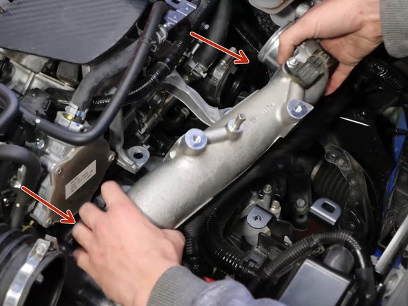 Once those are removed, you can lift the pipe upwards and out of the engine bay.