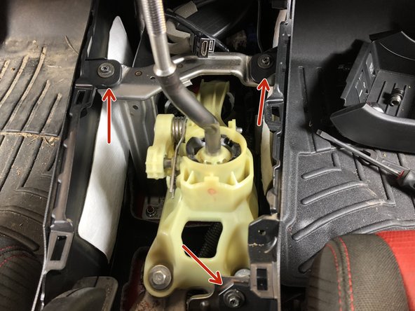 Remove the three mounting screws that hold the center console to the chassis brackets.