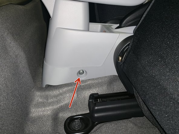 Remove the two screws on each side of the rear console. Slide the seats forward to access.