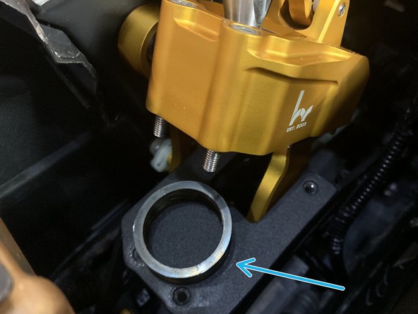 Once the four bolts have been removed, lift the shifter assembly up and the lower spring will come out of the bottom.