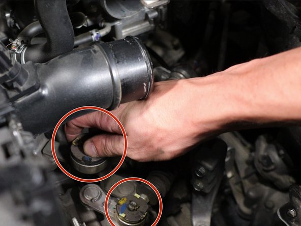 Remove the cotter pins from the shifter cables.