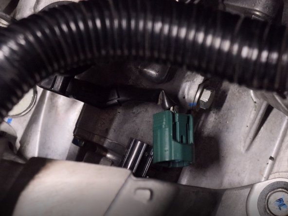 Unplug the reverse sensor on the top of the transmission.