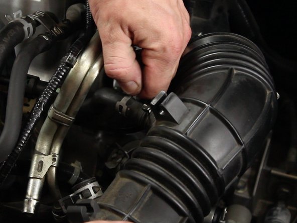 Unclamp and remove the air assist valve tube from the intake tube.