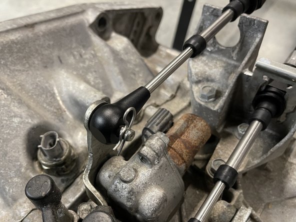 Then, install the cable in the bracket and lock it in place using a spring C clip.