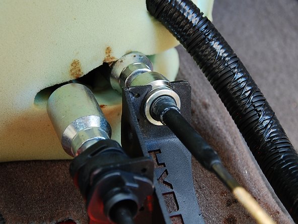 Next slide the right side cable into the shifter (1st picture) and install the C-clip to secure the cable (2nd picture).