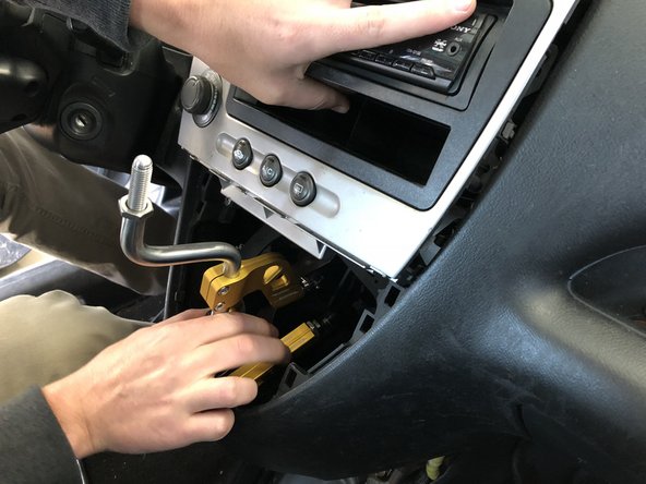 Insert your new Hybrid Racing shifter into the dash by holding the dash center out of the way. This shifter is much smaller so it should slide in easy.
