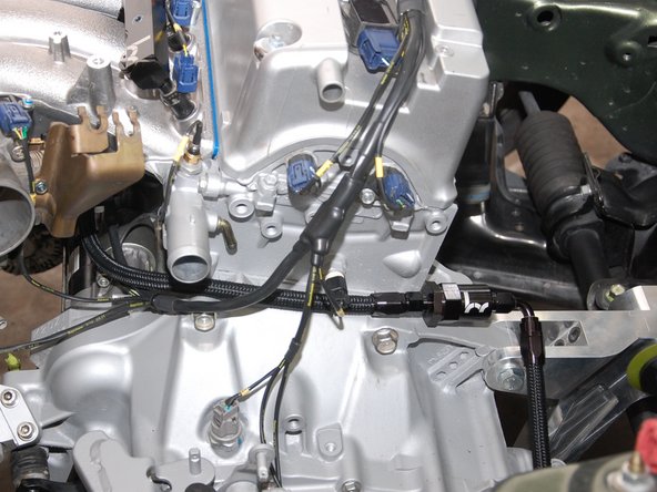 Connect line (B) to the fuel filter and swivel the 90* fitting so it positions the line towards the LH side shock tower.