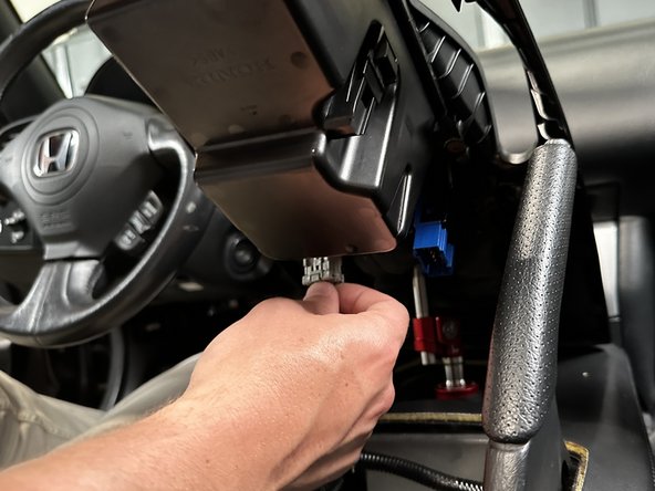 Re-install the center console. Be sure to connect all switches.