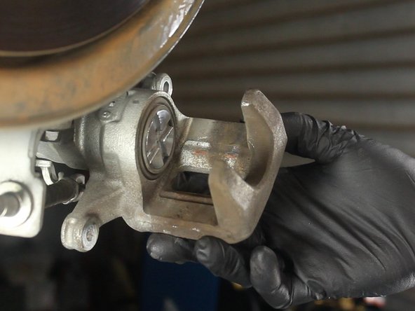 The rear piston rotates into the housing. Unlike the front piston compressing straight into the housing. 