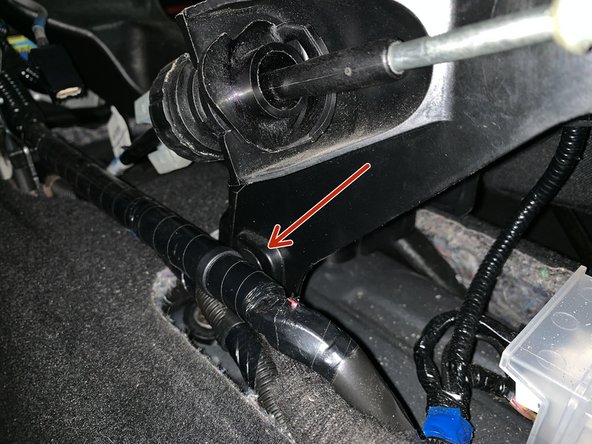 Remove the clips that hold the wiring harness to the factory shifter.