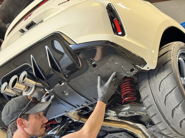 Pull the center section downward while pushing the side upward. The panel should bow which allows you to slide one end out.