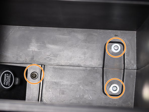 Inside of the arm rest compartment, there are (x3) Phillip screws. Remove all three.