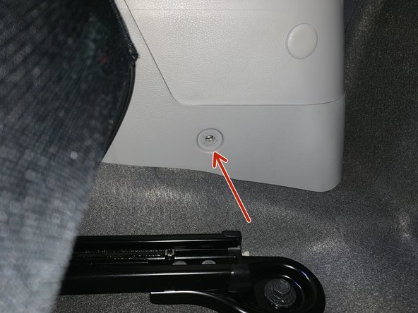 Remove the two screws on each side of the rear console. Slide the seats forward to access.