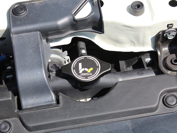 Once you have safely removed your factory radiator cap, install the Hybrid Racing unit by turning it clockwise.