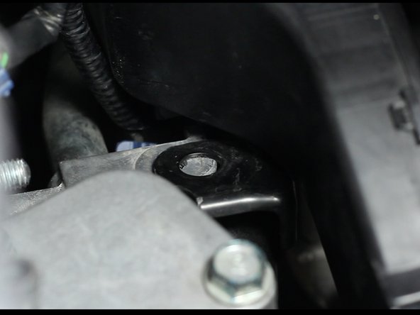 Locate and bend the heater hose pipe tab up and away from the OEM coolant housing.