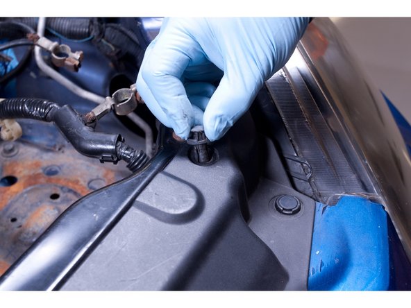 Remove the bumper. Start by removing all of the clips that hold the top section of the bumper and grille in place. There are 6 clips.