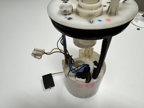 Unplug the fuel level sending unit. It is the connector with the yellow wire.