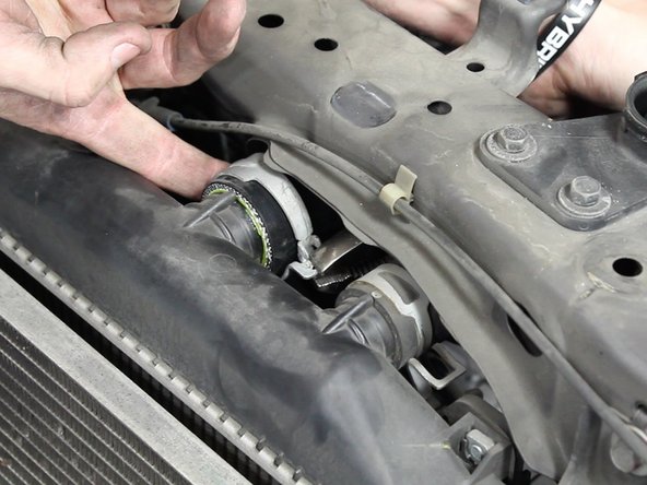 Install the new upper radiator hose and slide the clamps back into place.