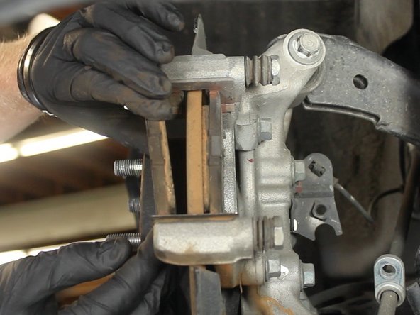 Apply brake pad grease to the back of each brake pad and each end where it contacts the caliper.